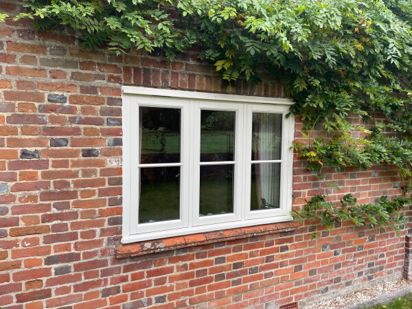rectangular casement windows on a brick wall