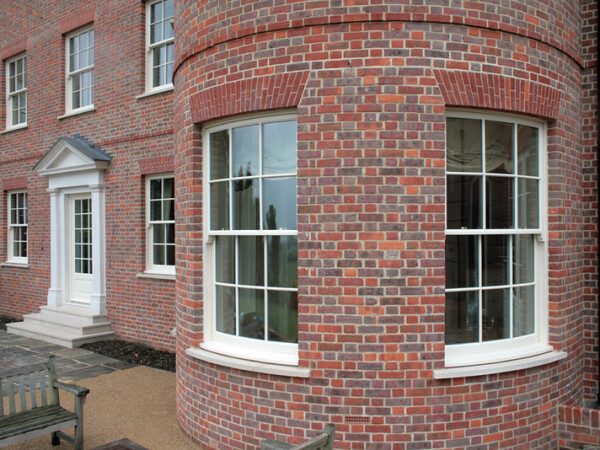 curved brick wall with sash windows