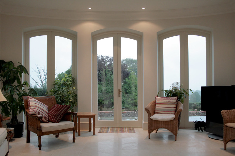 White arched timber french door